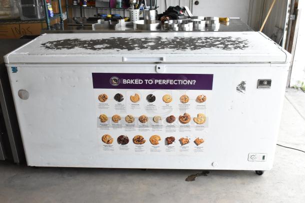 Kelvinator KCCF210WH metal chest freezer with hinge lid. Visible wear on top, attached cookie poster, 115V, 1 Phase.