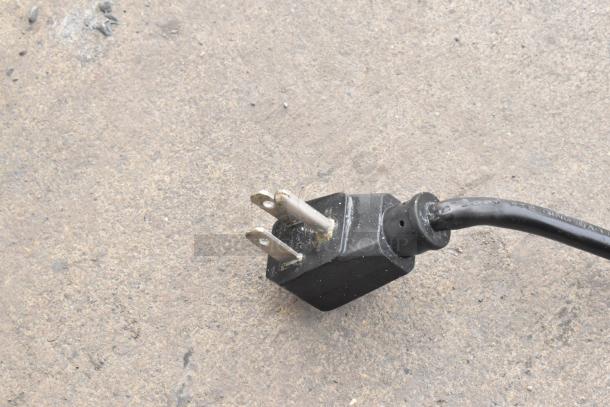 Plug for Kelvinator KCCF210WH metal chest freezer, 115 volts, 1 phase, shown on ground, indicating power connection type.
