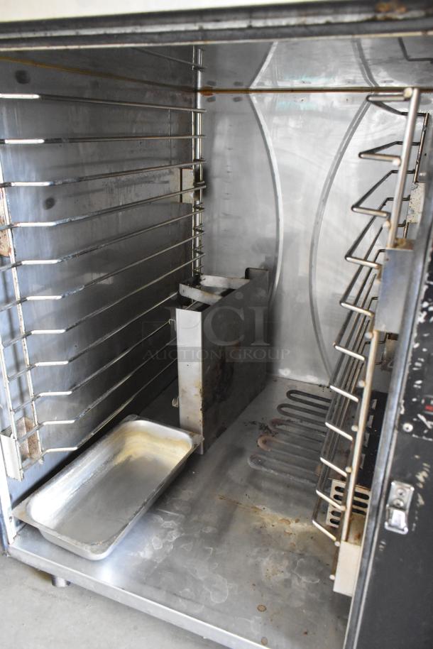 FWE TS-1826-7UC stainless steel heated holding cabinet interior, with shelves and commercial casters.
