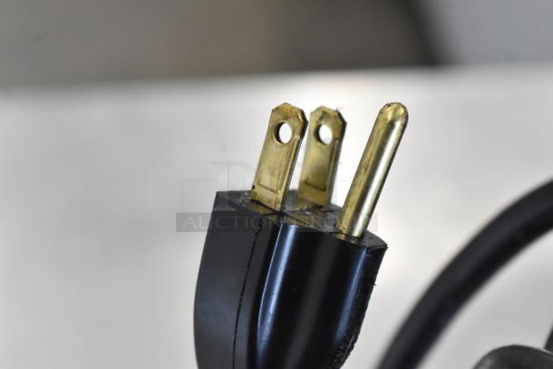 A close-up image of a three-prong power plug, part of the FWE TS-1826-7UC Heated Holding Cabinet.