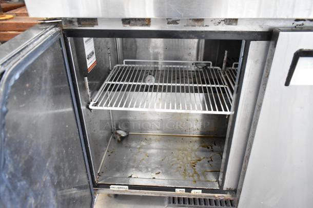2017 Bison BUR-72 stainless steel 3-door undercounter cooler, 115 volts, showing interior condition with shelving and labels.