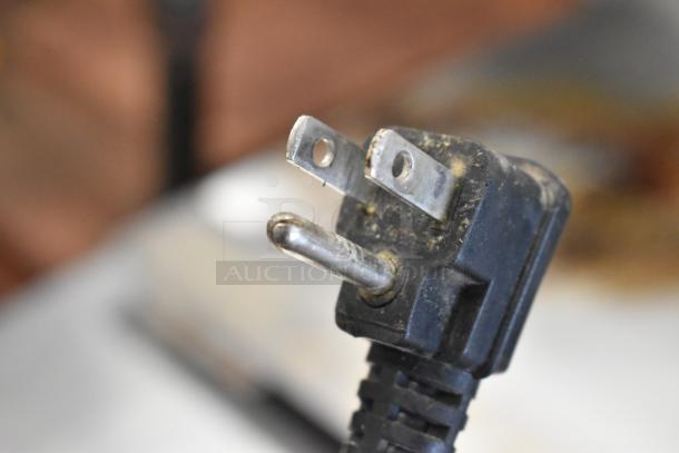 Close-up image of a three-prong electrical plug for the 2017 Bison BUR-72 commercial cooler, showing slight wear.