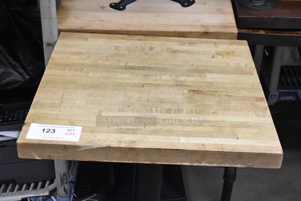 8 tables with wooden tabletops, square design, sturdy condition. Auction tag indicates quantity of 8 with item number 123.