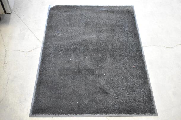 Three black floor mats, rectangular, in good condition, textured surface, durable material. Auction offers three times your bid.