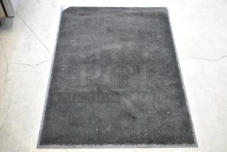 Three black floor mats, rectangular, in good condition, textured surface, durable material. Auction offers three times your bid.