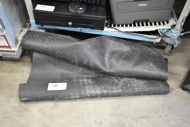 Black floor mats with subtle lattice pattern, gently used. Auction label showing item number 124 and quantity 3.