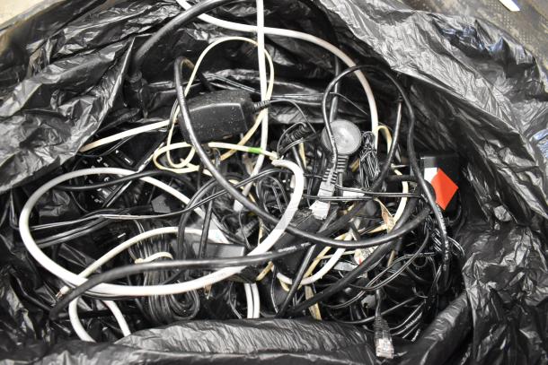 Lot of tangled cables and wires for POS system components, including power cords and Ethernet cables, in a black bag.