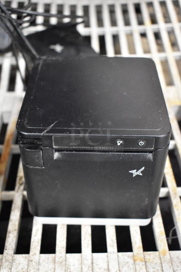 Lot of POS equipment featuring Epson receipt printer, black, with visible power and paper feed icons, in good condition.