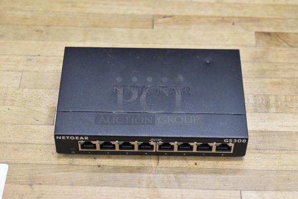 Netgear GS308 Gigabit Ethernet switch, 8 ports, black, used condition, part of POS system auction lot.