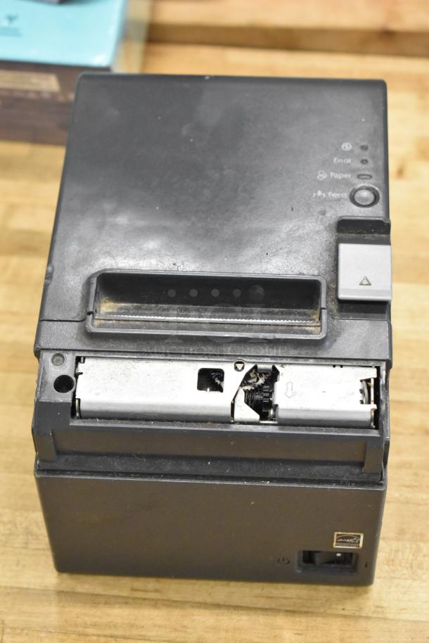 Epson receipt printer in used condition with visible marks and buttons. Part of a POS system auction lot.