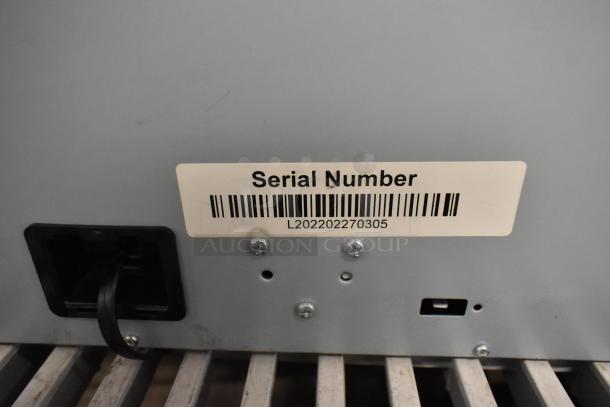 POS system lot back panel with serial number label L202202270305. Features power input and connection ports.