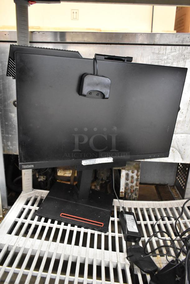 Lot of POS system items, including a Lenovo ThinkCentre monitor, on a metal shelf. No visible defects.