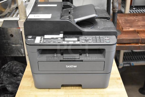 Brother MFC-L2710DW copier scanner printer, visible control panel, used condition. Model and brand markings on front.