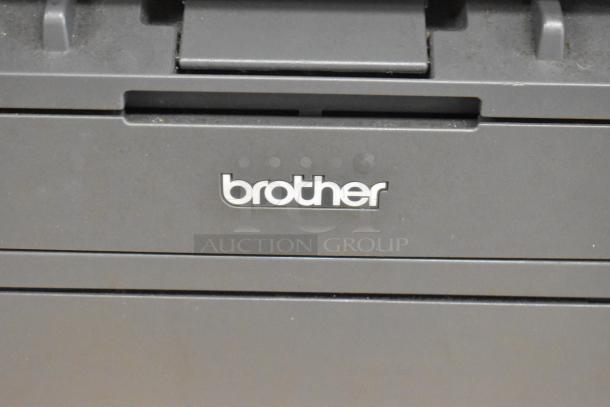 Brother MFC-L2710DW copier scanner printer, black finish, closely showing the logo and surface details.