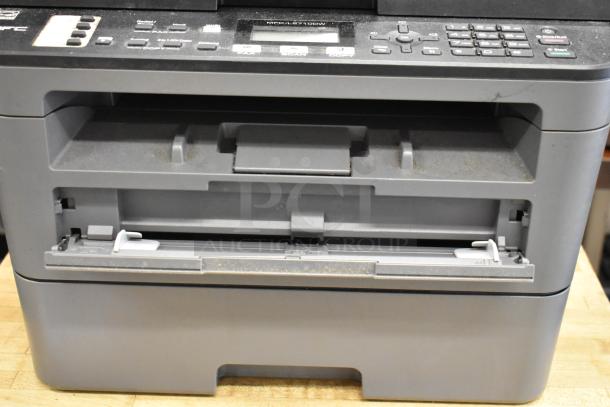 Brother MFC-L2710DW copier scanner printer, countertop model, showing control panel and paper tray, in used condition.