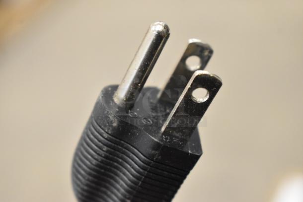 Close-up image of a black power plug for an electronic device.