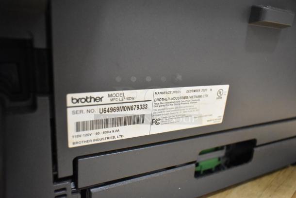 Brother MFC-L2710DW Printer, model shown with serial number U64969M0N679333, manufactured December 2020.