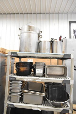 Lot of kitchen items on shelves: large stock pots, stainless steel bins, bowls. Includes label "127." Used condition.