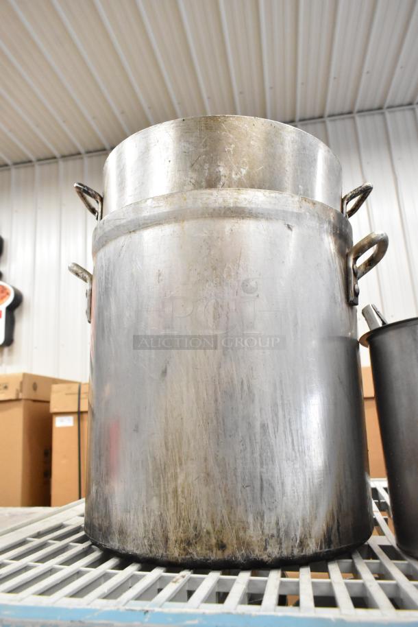 Lot of kitchen items including large stainless steel stock pot. Features handles, visible wear, for auction.