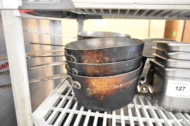 Lot of three tiers of items: vintage stock pots, stainless steel bins, and bowls. Condition shows wear. Auction tag visible.