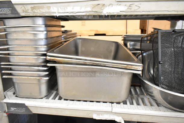 Lot of commercial kitchen items with stock pots, stainless steel bins, and bowls on storage shelves. Used condition.