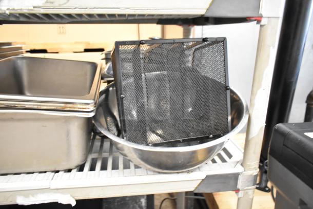 Lot of kitchen items on shelves including stock pots, stainless steel drop-in bins, and bowls. Various sizes, used condition.