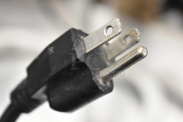 Close-up of a standard three-prong plug for the DL2112-S Metal Countertop 2 Heat Warming Lamp, 120 Volts, 1 Phase.