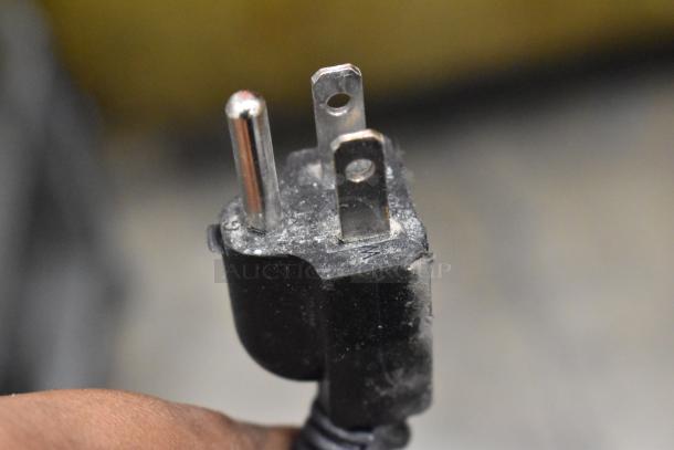 Close-up of a three-pronged plug for the 2024 Vevor KTR-48B1 cooler, 115 volts, showing signs of use.