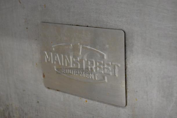 Mainstreet stainless steel commercial gas-powered 6 burner range with oven, over shelf, and backsplash. Brand plaque shown.