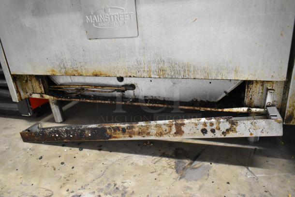 Mainstreet stainless steel 6 burner gas range with oven, over shelf, and backsplash. Used condition with visible wear and grease stains.