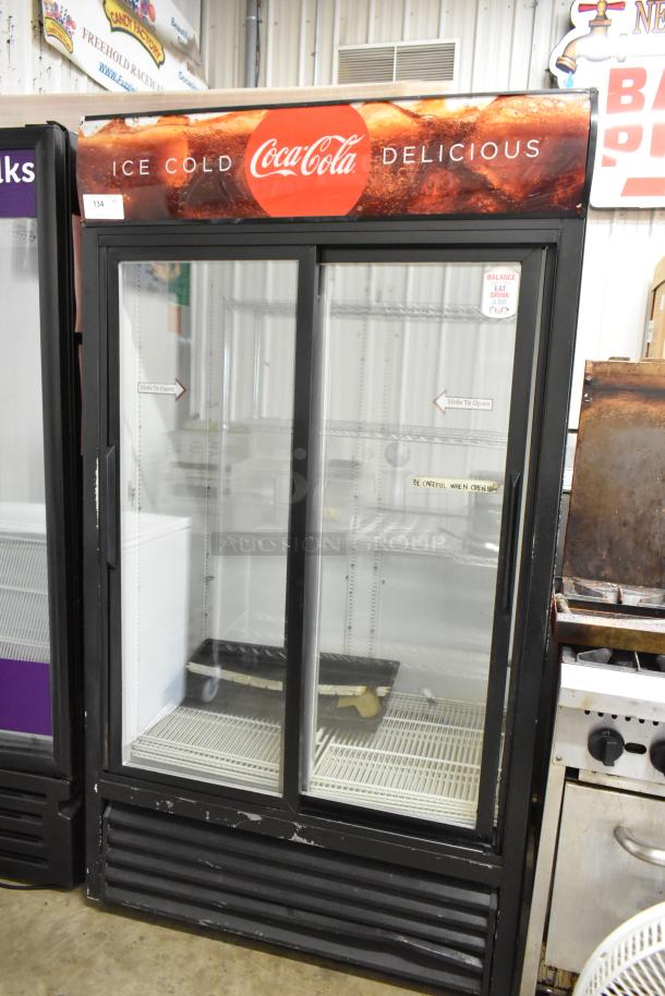 True GDM-37 commercial cooler, 2 glass doors, poly-coated racks, Coca-Cola branding, 115V, 1 phase, good condition.