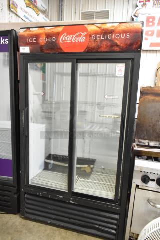 True GDM-37 commercial cooler, 2 glass doors, poly-coated racks, Coca-Cola branding, 115V, 1 phase, good condition.