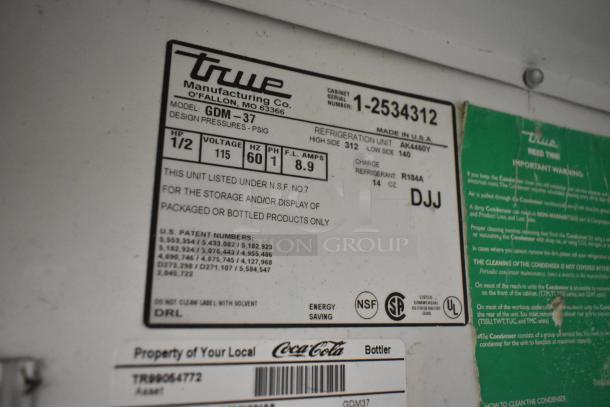 True GDM-37 commercial cooler label, shows model, voltage (115V), phase (1), refrigerant type R134A. NSF-certified.