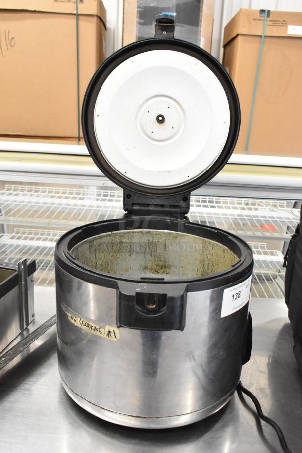Amko AK-60ERC stainless steel countertop rice cooker, 120 volts, 1 phase. Used condition, visible wear inside.