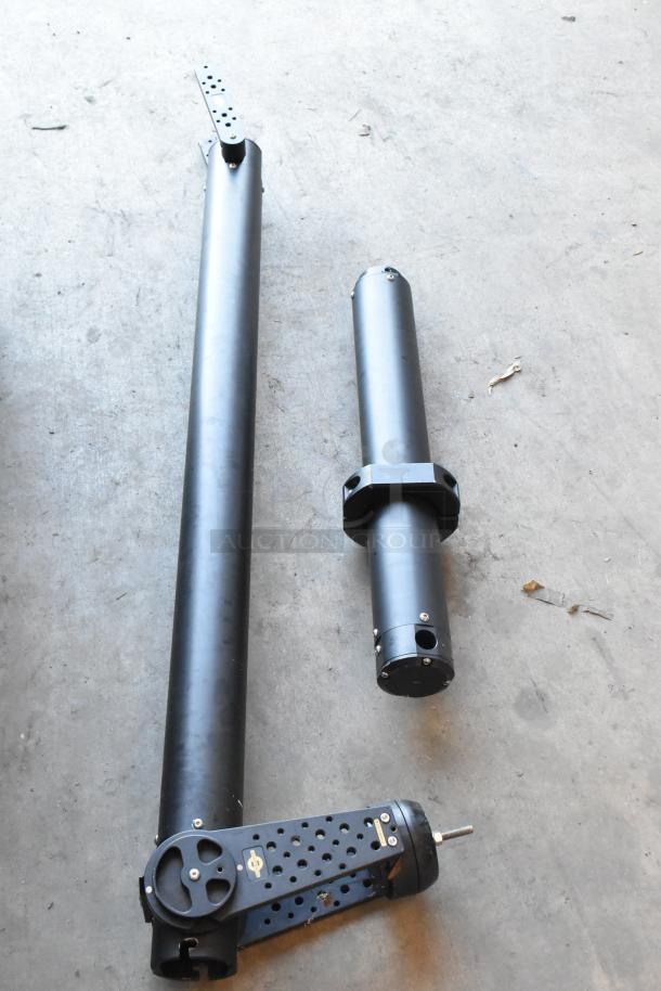 2 Pocket Jib Pro / Cinevate in black bags on concrete floor, showing two components in good condition.
