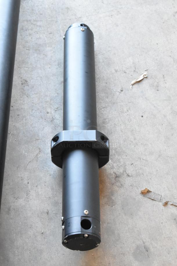 Cinevate 2 Pocket Jib Pro in black bags, shown on concrete floor. Features durable construction, in good condition.
