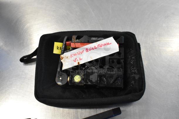Black bag with Kessler Quick Release V2, labeled "Kessler Quick Release V-2," showing signs of wear.