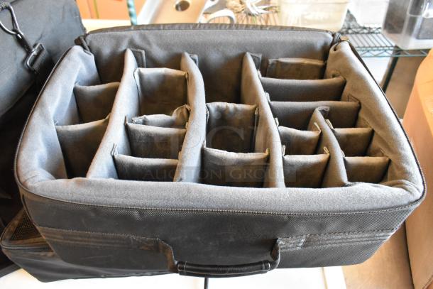 Black bag with multiple padded compartments, ideal for organizing equipment; durable fabric, excellent condition.