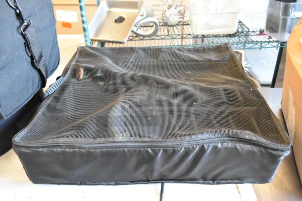 Four black bags with mesh tops, containing various items, in good condition, ready for auction bidders.