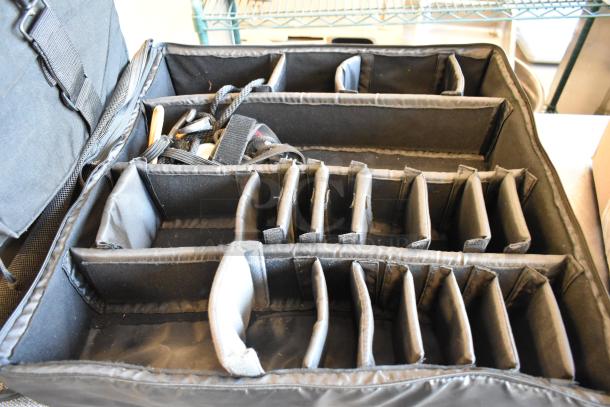4 black bags with compartments and contents. Durable material, excellent condition. Ideal for organized storage.