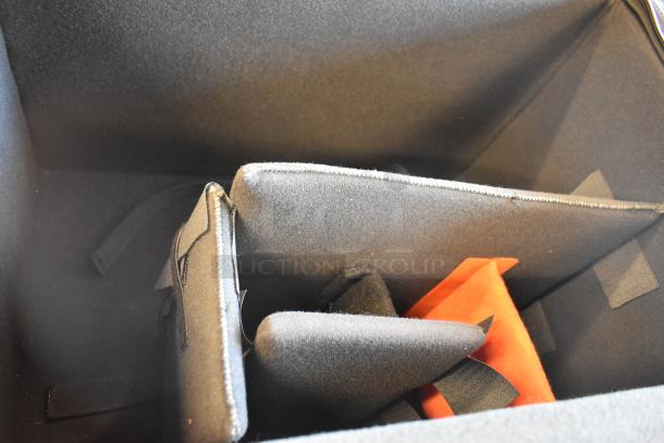 4 black bags with contents, displaying internal dividers and a hint of orange material, suggesting potential adaptability and storage use.