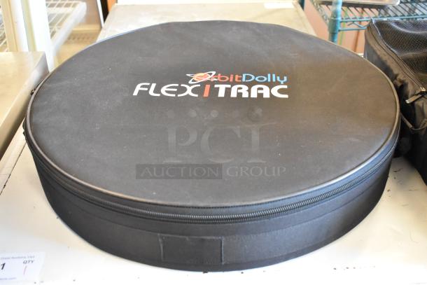 Black round carrying case with "Orbit Dolly FLEXITRAC" logo, part of a set of 4 bags with contents.