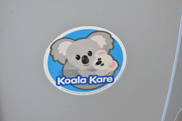 Koala Kare gray wall mount diaper changing station with logo featuring two koalas. Durable, clean condition.