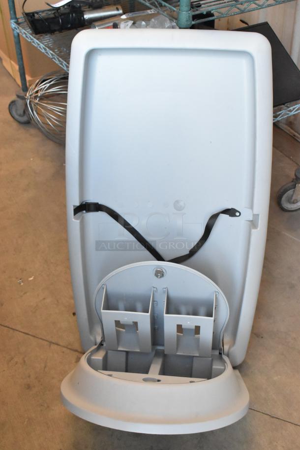 Koala Kare gray wall mount diaper changing station, features a fold-down design, safety strap, used condition.