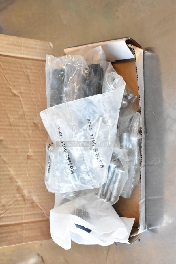 Auction item lot with 3 metal legs, universal gas hose, TV mounting hardware pack. Includes labeled bolts in a box.