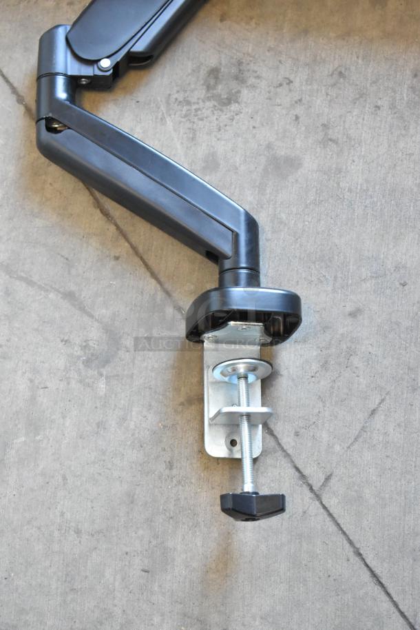 Element EM2FPAB24B monitor wall mount arm, black, adjustable, with a sturdy metal clamp for secure attachment.
