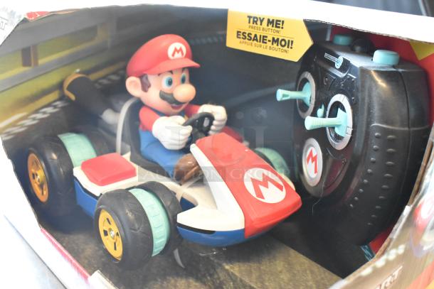 Remote-controlled Mario Kart toy with Mario figure, controller, in original packaging. Features "Try Me" button for demo.