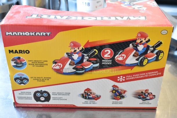 Mario Kart remote-controlled toy box showing 2 modes, anti-gravity and race, with 100 ft range. Features images of spins and drifts.