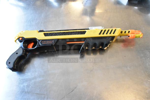 GiveBest PTC-905 salt gun, black and yellow, "Do not shoot in face or eyes" caution label, auction item.