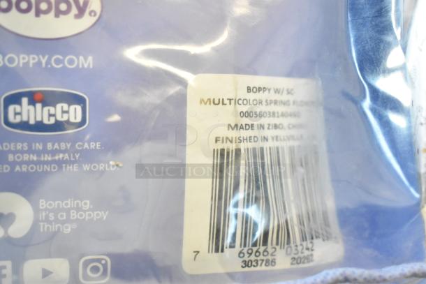 "Chicco logo on Boppy pillow packaging; tag details: multicolor spring flowers, made in Zibo, China, barcode visible."